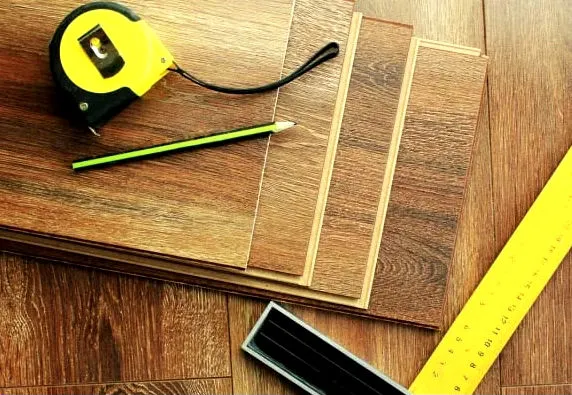 Measuring tapes and wooden flooring planks